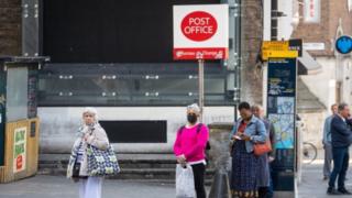 People wait at Post Office