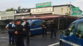 Police officers patrol in front of the scene of a car crash into a pizza restaurant on August 15, 2017 in Sept-Sorts