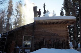 David stands on the roof of the house