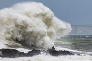 Waves crash against the harbour wall on 10 August 2019 in Porthcawl, Wales.