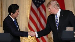 President Donald Trump and Japanese Prime Minister Shinzo Abe shake hands at a news conference at Mar-a-Lago on April 18, 2018