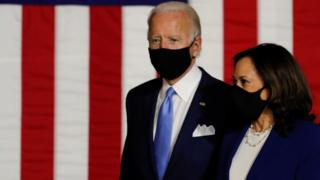 Democratic presidential candidate Joe Biden and vice presidential candidate Senator Kamala Harris take the stage at a campaign event.