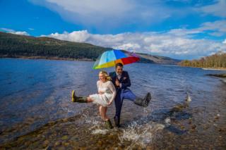 Newly weds in wellies in Loch Ness