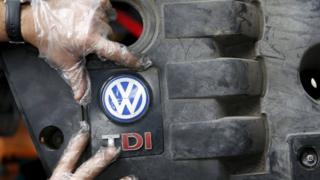 Volkswagen logo and technician