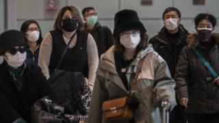 Passengers wear protective masks in Beijing