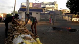 Protesters erect a barricade along a street during demonstrations in central Khartoum, Sudan May 15, 2019