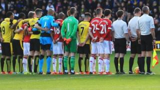 Watford and Manchester United players line up in the centre circle before Saturday's game