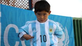 Afghan boy Murtaza Ahmadi posing with a jersey sent to him by Argentine football star Lionel Messi in 2016