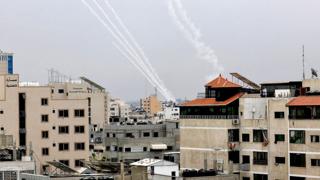 Rockets are fired from Gaza towards Israel, in Gaza, on 9 October 2023