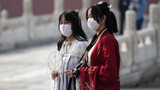 Two Chinese women in face masks