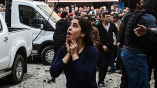 A woman reacts as she looks at the site of a strong blast near the riot police headquarters in the centre of Diyarbakir, south-eastern Turkey, on 11 April 2017
