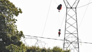 The pilot was suspended for some time before rescuers were able to reach him