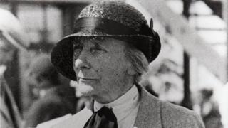 Dame Ethel Locke King in the paddock with a programme c.1935
