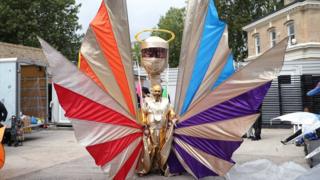 A performer from the mas band Mahogany prepares to be filmed in a studio in Kennington, London, before Notting Hill's first virtual carnival.