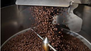 Coffee beans pour out of the roaster at The Chosen Bean Specialty Coffee company on April 24, 2019 in Oakland Park, Florida