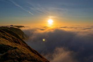 Sunrise over clouds