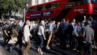 Commuters getting onto a bus