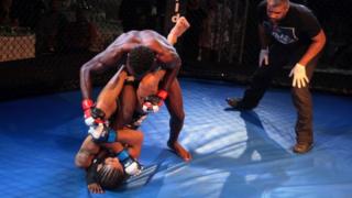 Jad Akach of Lebanon (bottom) fights Jonathan Lamptey of Ghana (top) during the Warrior Sports Championship Africa Mixed Martial Arts (MMA) bout 3 in Bukom Fighting Arena, Accra, Ghana, 20 July 2018.