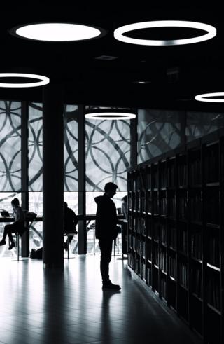 Silhouette of a man in a library