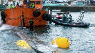 Guardia Civil divers inspect the suspected narco-submarine in Aldán, Galicia