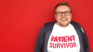 red background and Stuart smiling