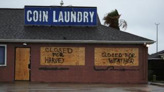 Sign on a business reading "closed for Harvey"