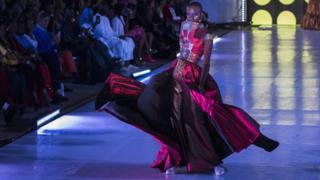 Senegalese model Alima Diop poses on the catwalk wearing a design by Algaye during Dakar Fashion Week in Dakar, Senegal