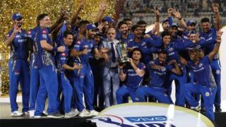 Mumbai Indians players celebrate on the podium after winning the 2019 IPL title