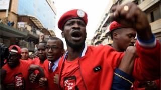 Robert Kyagulanyi (C) is joined by other activists in Kampala on July 11, 2018 in Kampala during a demonstration to protest a controversial tax on the use of social media.