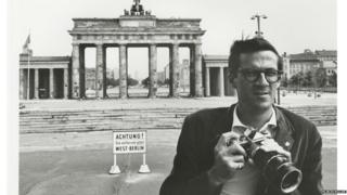 Flip Schulke in front of the Brandenburg Gate in West Germany, early 1960s