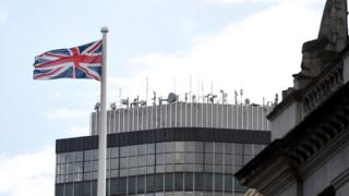 A Union Jack flies in front of the Millbank Tower by the River Thames where RT is based in London, 17 October