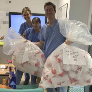 Hospital staff with donated water bottles
