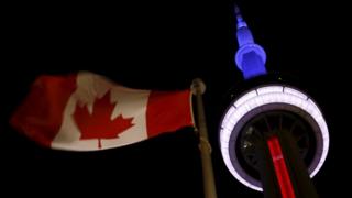 The landmark CN Tower is lit blue, white and red in the colors of the French flag following Paris attacks,