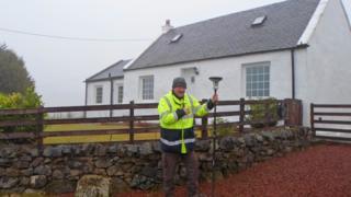 Taking a measurement at the highest house in Scotland