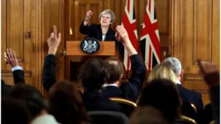 Theresa May pointing to journalists