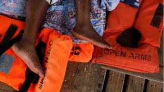 Rescued Cameroonian migrant Josepha, 40-years-old, rests on board the Spanish NGO Proactiva Open Arms boat as it sails back to Spain in the Mediterranean Sea, 17 July 2018