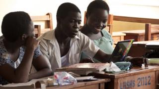 Labone Senior High School students Ernestina Quaye (L), Narteh Andrews (C) and Lisa Okudzetp (R) sit in a classroom on December 1, 2012 in Accra
