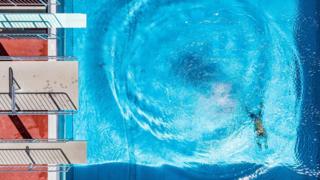 A man dives in an open air public pool in Straubing, southern Germany, where temperatures reached up to 34 degrees Celsius on June 26, 2019.