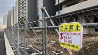 Знак «Не входить» на заборе в деревне спортсменов в Токио