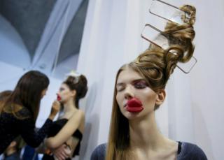 A model waits backstage during Ukrainian Fashion Week in Kiev, Ukraine