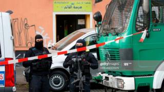 Police stand in front of Al-Irschad Mosque during a raid on April 30, 2020 in Berlin