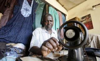 Tailor Mohamed Diallo sews at his local fashion shop in Dixinn neighbourhood, Conakry, Guinea, 17 February 2020.