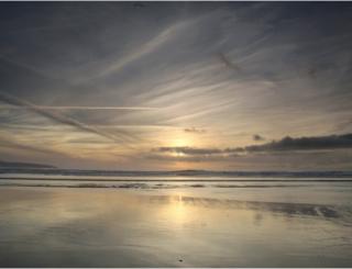 Sunset mirrored on a beach