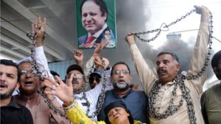   Nawaz Sharif's supporters shout slogans one day after being sentenced to 10 years in prison 