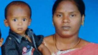 Sujith on his mother's arm with his brother and father