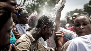 A supporter of Felix Tshisekedi being showered with power in Kinshasa, DR Congo - Thursday 10 January 2019