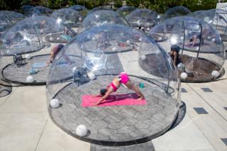 in_pictures People practise yoga in individual transparent domes