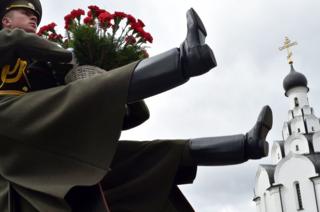 Honour guard soldiers lay flowers at the Chernobyl victims' memorial in Minsk