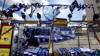 Winds in London blow at a Chelsea FC scarf stand.