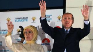 Turkey's President Recep Tayyip Erdogan and his wife Emine Erdogan greet supporters gathered at the AK Party headquarters in Ankara, Turkey